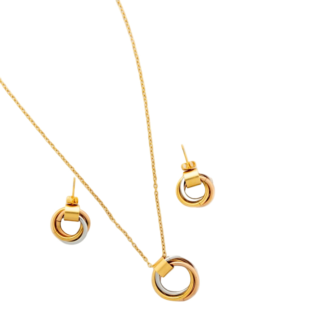 Gold necklace and earrings set on a white background