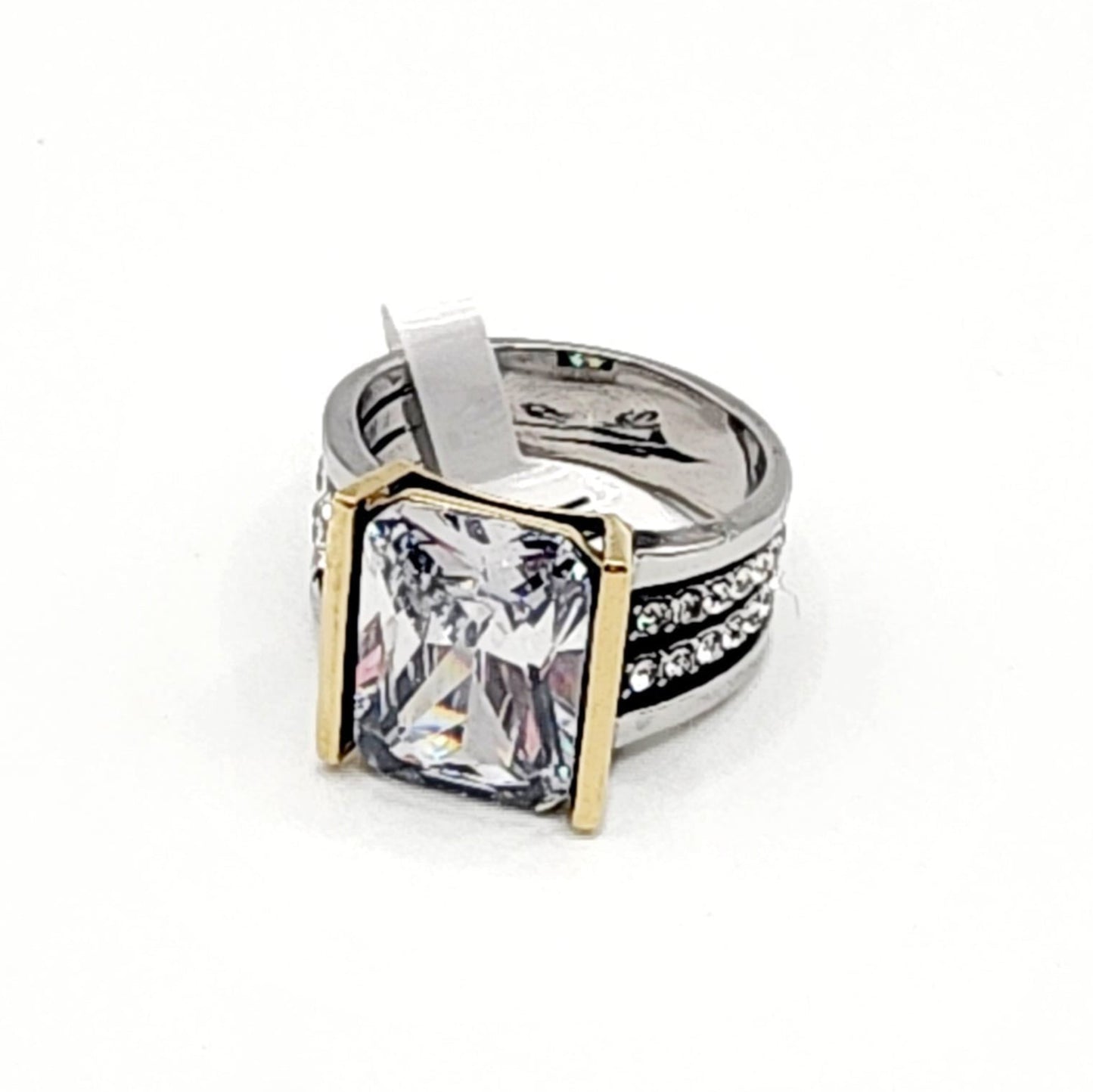 Silver ring with a large diamond and gold accents on a white background