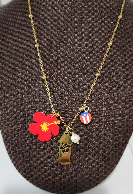 Necklace with various charms including a red flower, green hut, and American flag on a brown textured background.