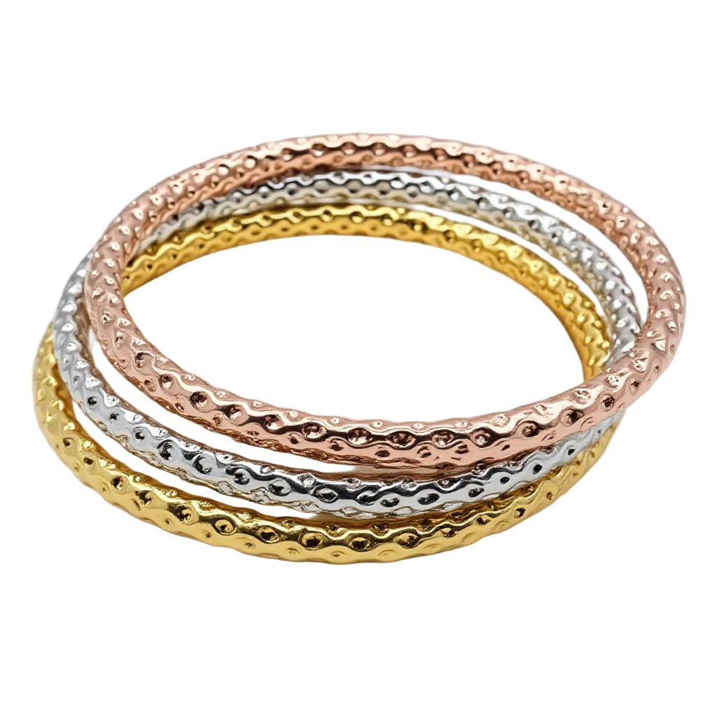 Three gold and silver bangles stacked on a white background